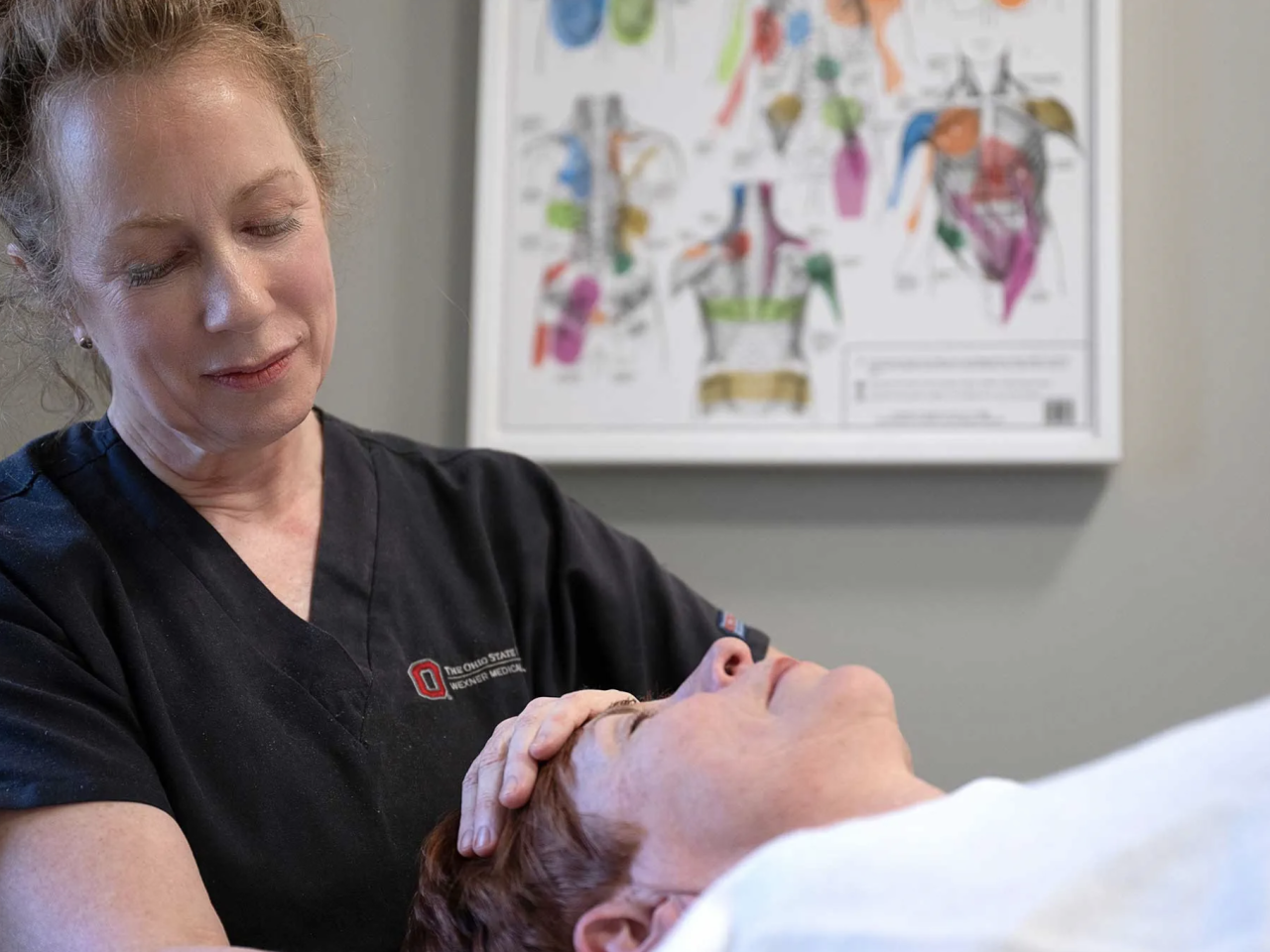 An Ohio State massage therapist giving a woman a massage
