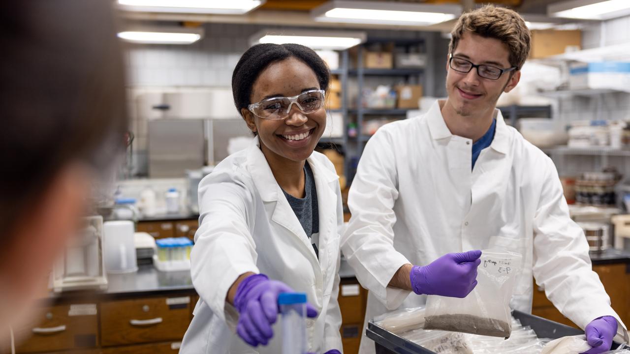 two people wearing white lab coats