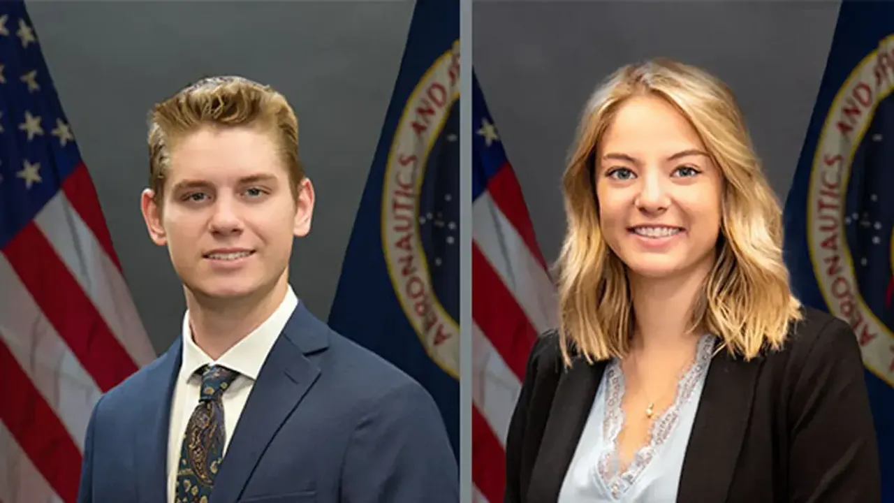 a young man wearing a blue blazer and a young woman wearing a black blouse