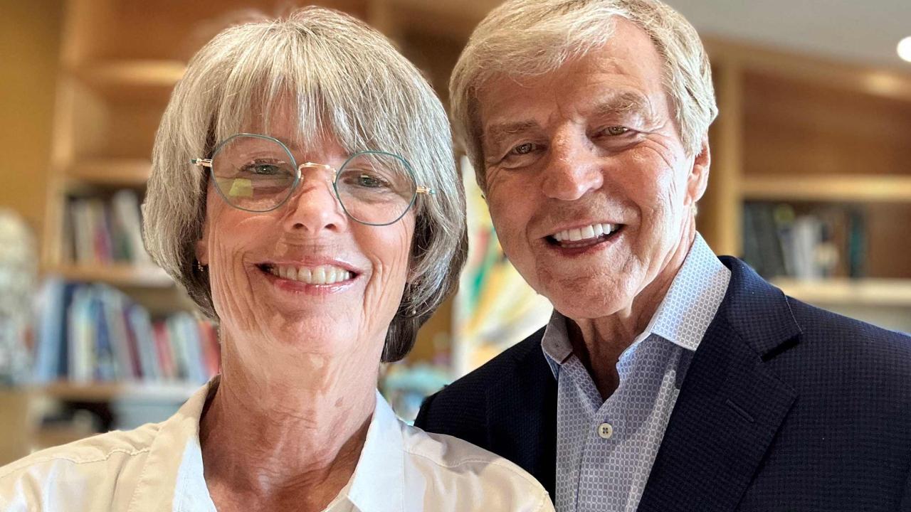 gray-haired woman and man smiling