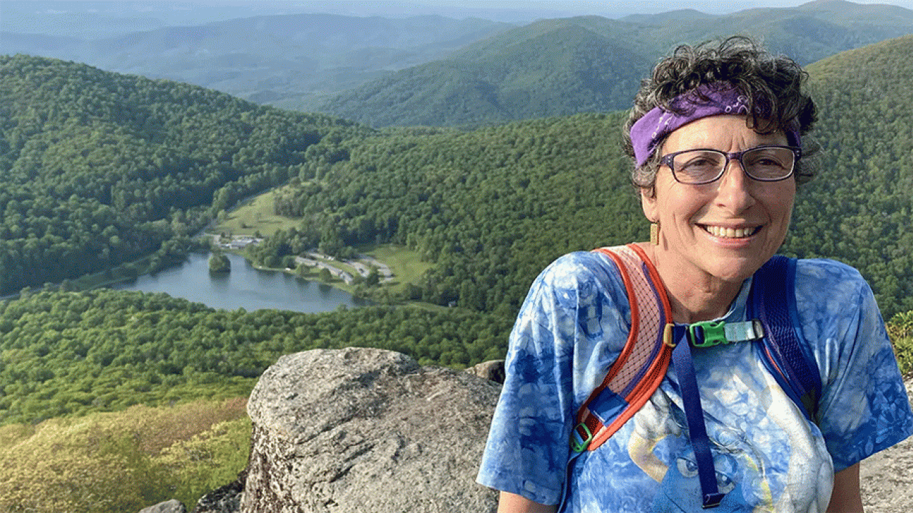 Sue Wasserman with a lush green valley in the background